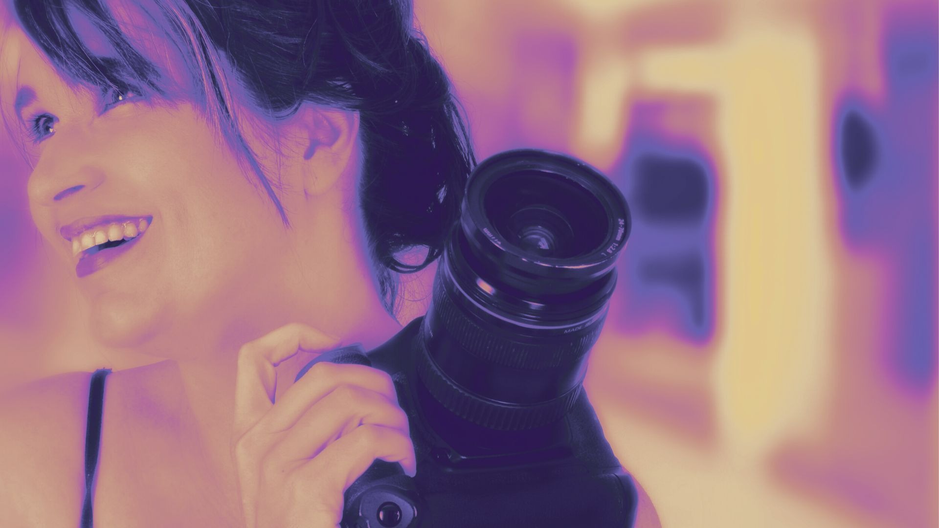 Female creative fine art photographer holding a camera and enjoying the art photography process